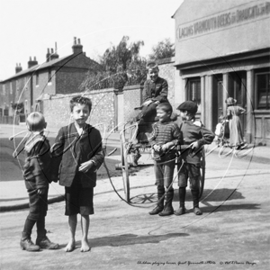 Kids playing horses in a street in Great Yarmouth in Norfolk c1900s